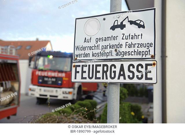 Sign, Feuergasse freihalten, German for keep clear lane for fire engines, fire engines at back during a fire fighting operation at a barn fire, Aichelberg