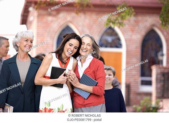 Older woman and granddaughter laughing