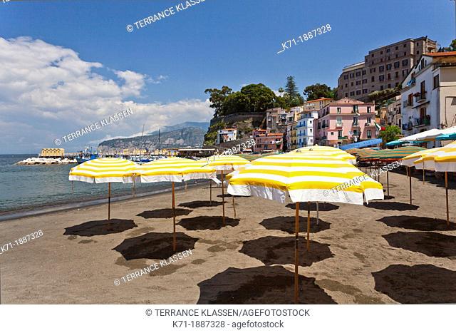 Yellow umbrellas on the sandy beach in Sorrento, Campania, Italy