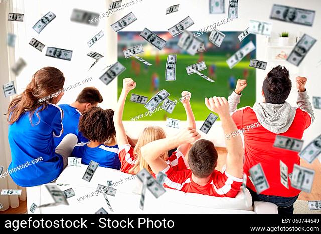 happy football fans watching tv over money rain