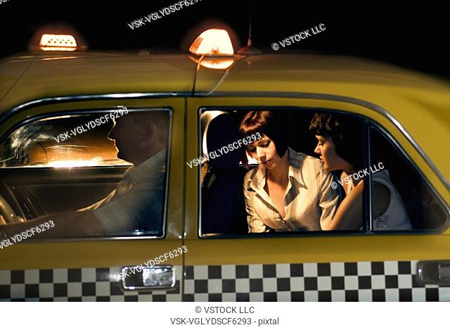 Women in backseat of taxi