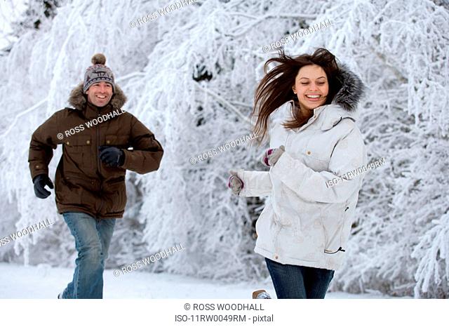 Couple running in the snow