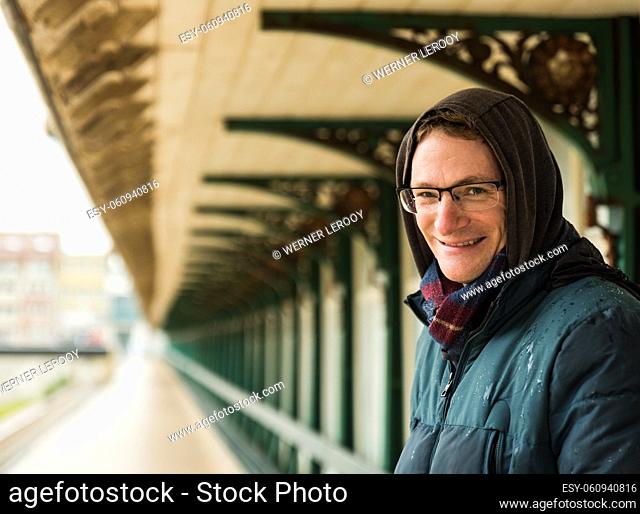 Portrait of an attractive white man , 40 years old with winter clothes on a windy day at the seaside, Blankenberge, Belgium