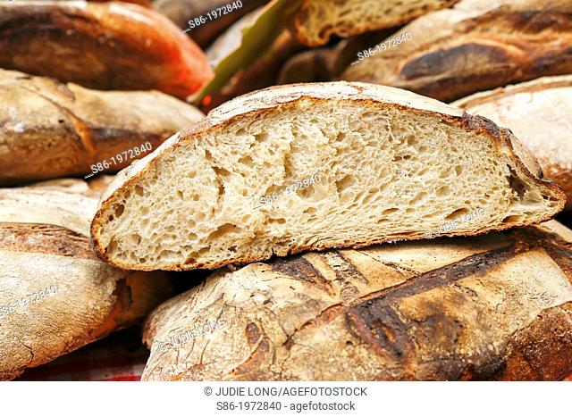 Freshly Baked Peasant Bread Offered for Sale in Parisian Food Market