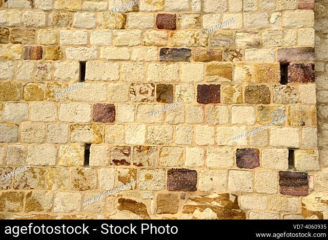 Wall built with sandstone blocks. Sandstone is a clastic sedimentary rock composed by quartz grains. This photo was taken in Zamora city, Castilla y León, Spain