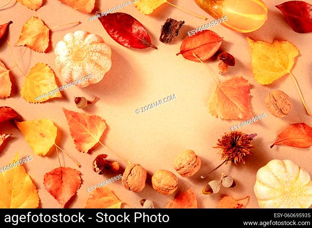 Autumn background with fall leaves, a flat lay, overhead shot with copy space on a brown background