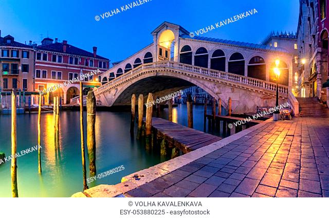 Panoramic view of famous Rialto Bridge over the Grand Canal in Venice at night, Italy
