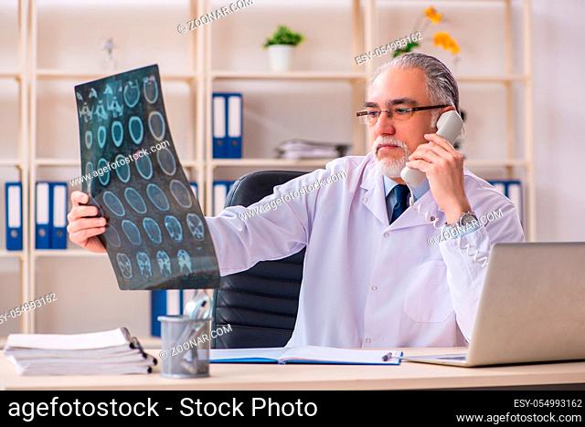 Aged male doctor radiologist in the clinic