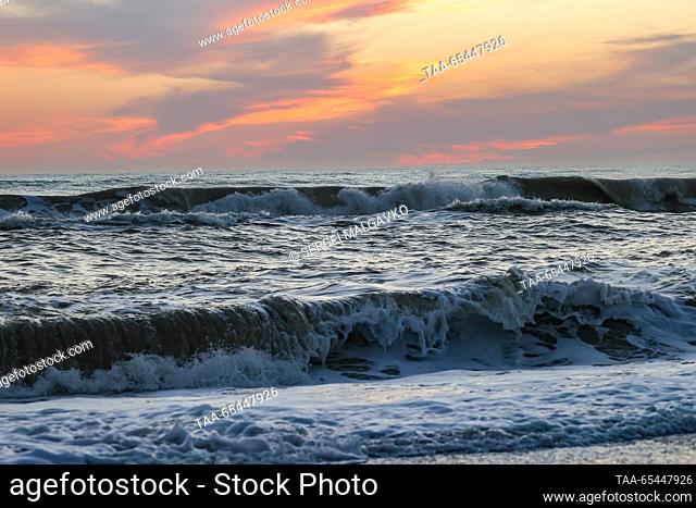 RUSSIA, REPUBLIC OF CRIMEA - DECEMBER 3, 2023: A view of rolling waves at the city of Yevpatoria on Crimea's Black Sea coast at sunset in winter