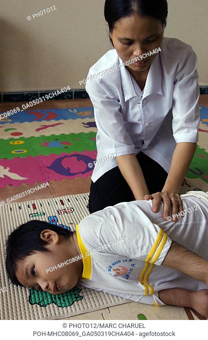 A nurse attending to an ill boy 2005