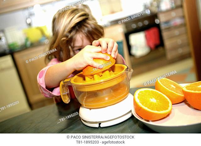 Girl preparing orange juice
