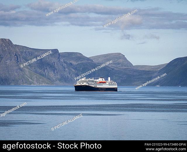 24 August 2023, Norway, Hammerfest: The ship ""Havila Polaris"" of the shipping company Havila Kystruten is sailing out of the fjord towards the port of...