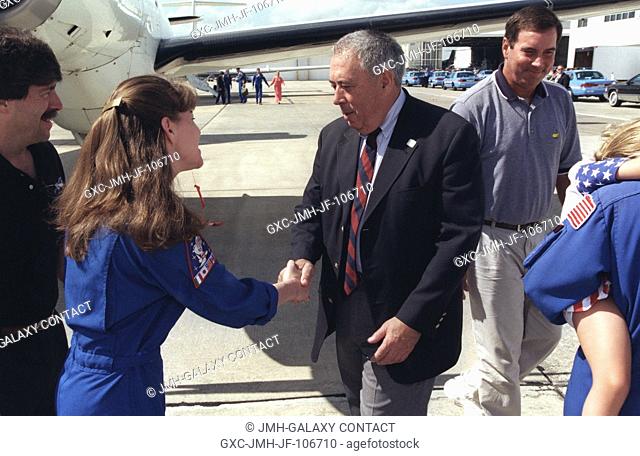 Johnson Space Center Director George W.S. Abbey greets astronaut Catherine G. (Cady) Coleman following the STS-93 crew arrival at Ellington Field