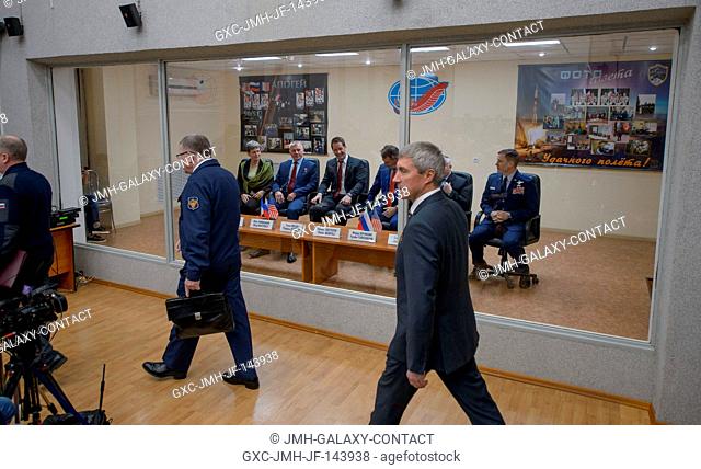 Expedition 50 prime and backup crews are seen in quarantine behind glass as they await the start of the State Commission meeting to approve the Soyuz launch to...