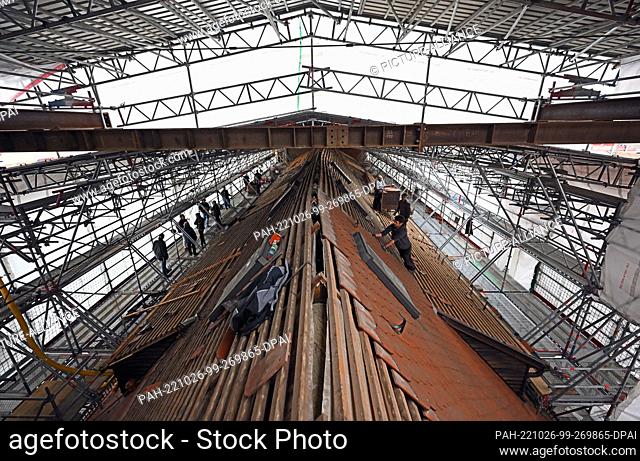 26 October 2022, Thuringia, Erfurt: Craftsmen work on the roof of the old convent building in the Ursuline Convent. With the completion of the scaffolding