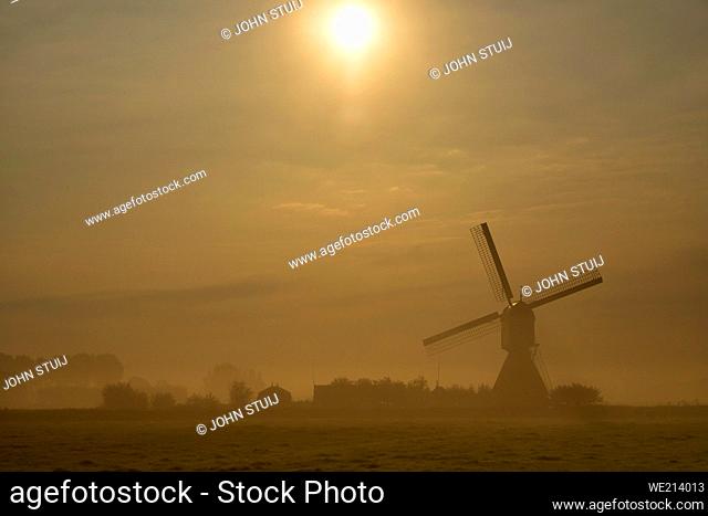 Windmill the Wingerdse Molen near the Dutch village WIjngaardem on a beautiful misty morning