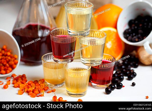 Currant wine in a bottle on wooden table. Sweet alcohol made from many varieties berry fruits
