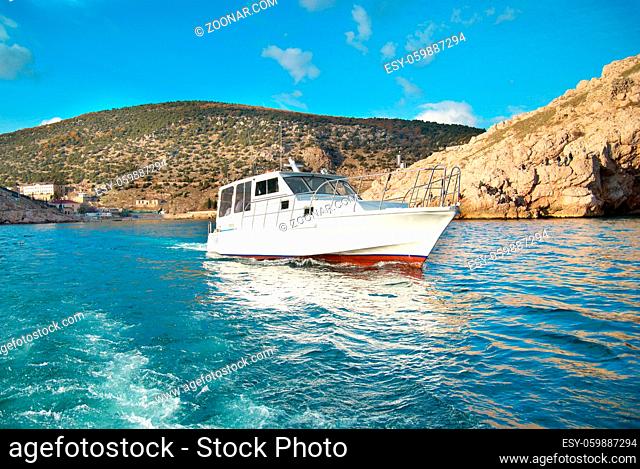 Motor boat cruising the sea near coast. Seascape
