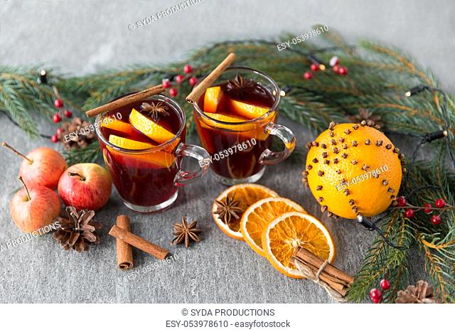 glass of hot mulled wine, cookies, apples and fir