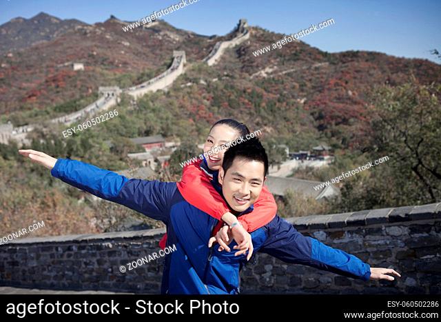 Young couples take pictures in the Great Wall Tourism high quality photo