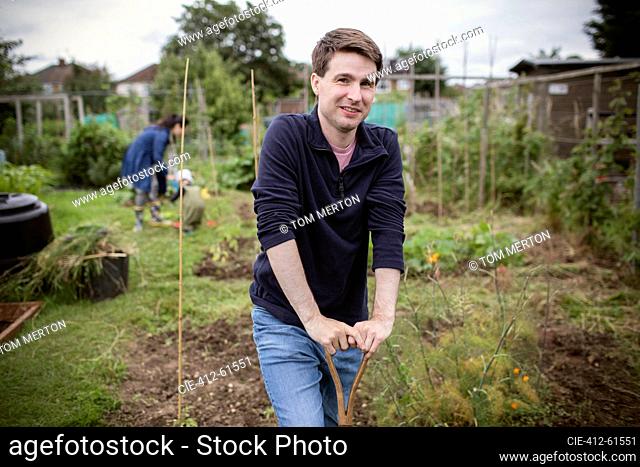 Portrait confident man gardening in backyard