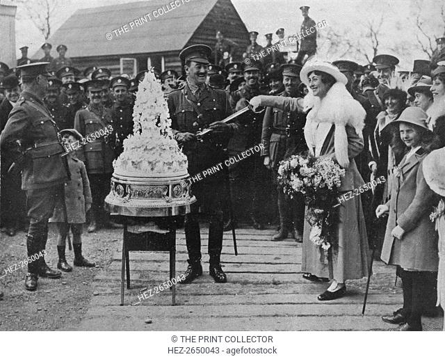 'A khaki wedding: Cutting the wedding cake with the bridegroom's sword', 1915. Artist: Unknown