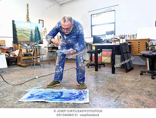 portrait of a painter artist who works in his studio