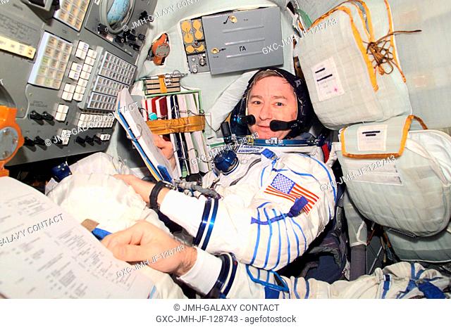 Astronaut Frank L. Culbertson, Expedition Three mission commander, wearing a Russian Sokol suit, is seated in the Soyuz spacecraft that is docked to the...
