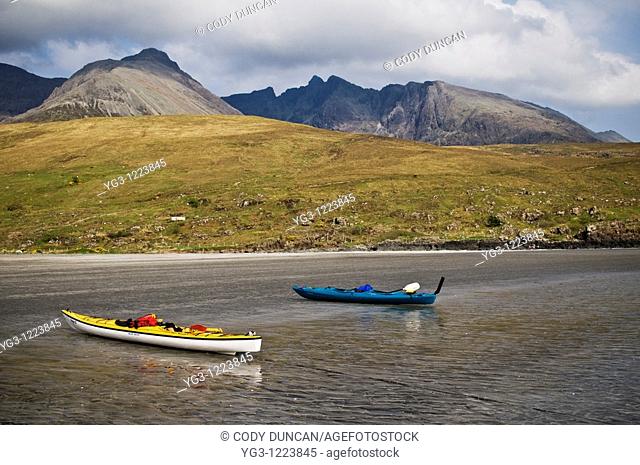 Two Kayaks on beach at Glenbrittle with Black Cuillins in background, Isle of Skye, Scotland