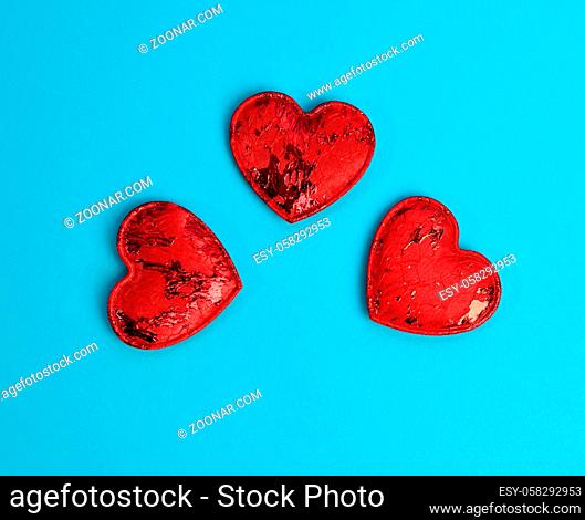 red textile small hearts on blue background, festive background, top view