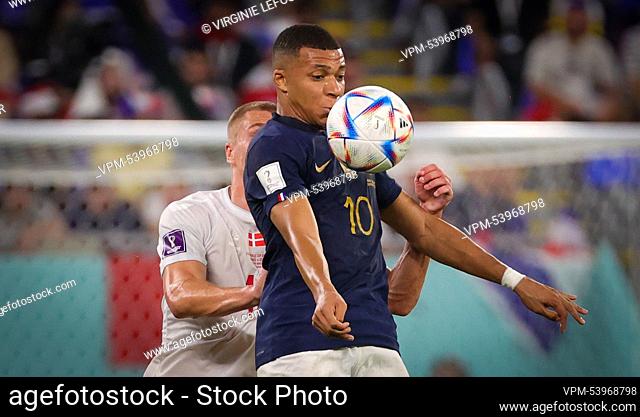 Danish Rasmus Kristensen and France's Kylian Mbappe fight for the ball during a soccer game between France and Denmark, in Group D of the FIFA 2022 World Cup