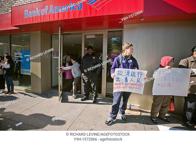Local community organizations rally in front of a branch of Bank of America in Chinatown in New York on Bank Transfer Day, Saturday, November 5