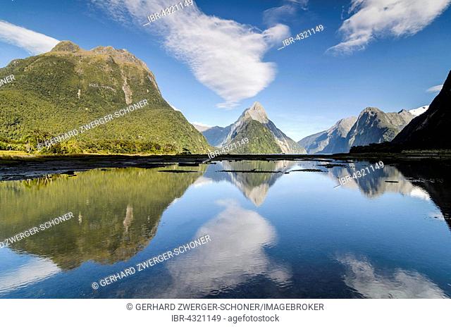 Mitre Peak with blue sky and clouds, reflection in the Milford Sound, Fiordland National Park, South Island, New Zealand