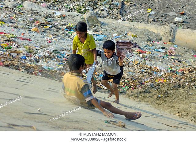 Street children playing at an embankment Kamrangir, Dhaka, Bangladesh February 11 2007