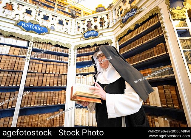 06 December 2023, Saxony, Ostritz: Elisabeth Vaterodt OCist, abbess, stands in the library at St. Marienthal Monastery. Saxony has acquired the historically...