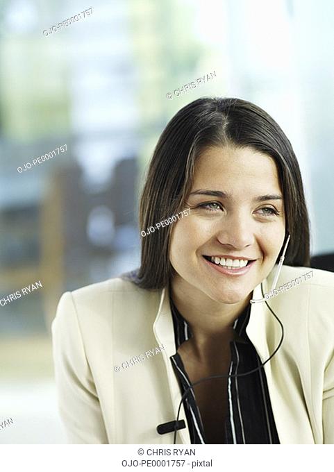 Closeup of businesswoman with headset smiling