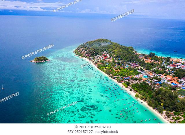 Aerial drone view of beautiful tropical Koh Lipe island with crystal clear lagoon sea water during sunny summer day, Thailand