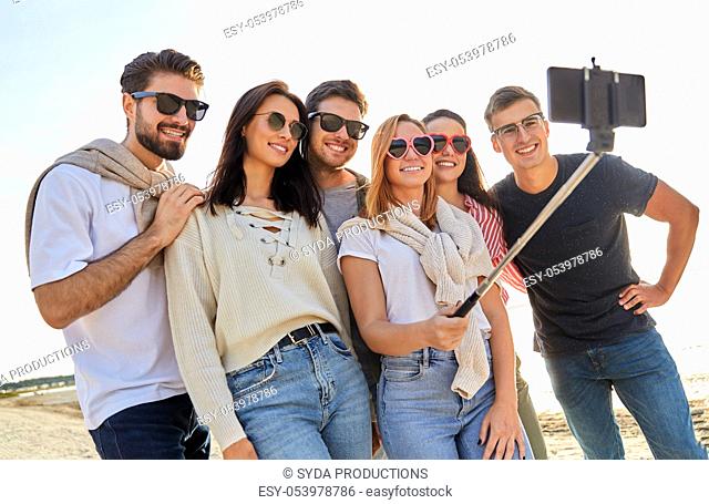 happy friends taking selfie on summer beach