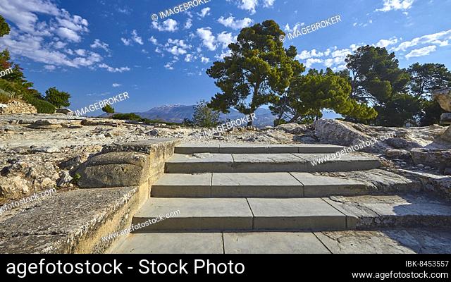 Morning light, blue sky, white clouds, stairs from below, trees, Ida massif, Minoan palace of Festos, Messara plain, central Crete, island of Crete, Greece