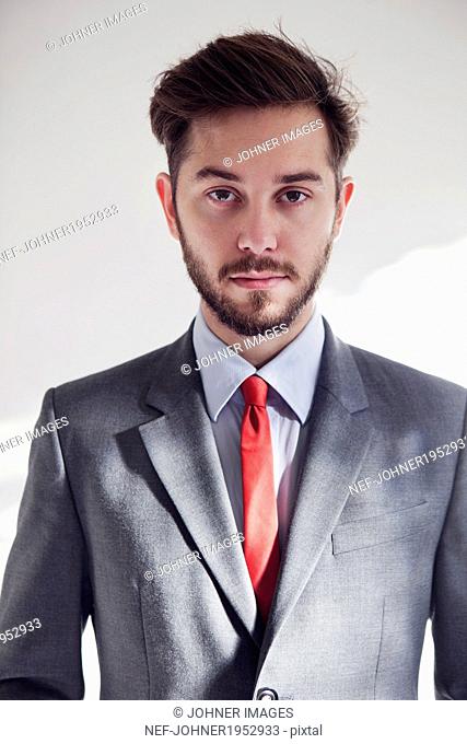 Portrait of young man wearing suit, London, United Kingdom