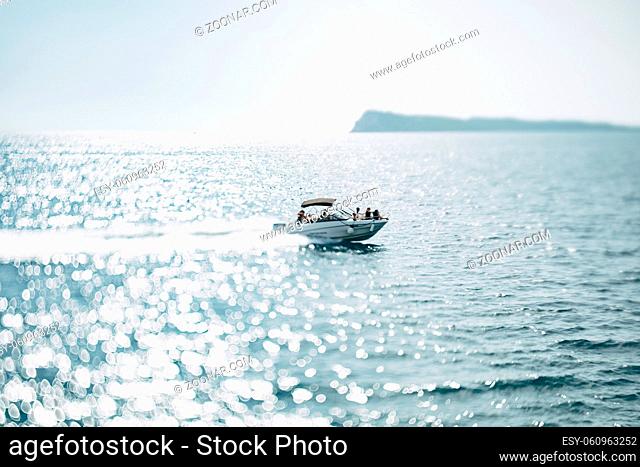 People sail on a white motor yacht in the open sea on a bright sunny day. High quality photo