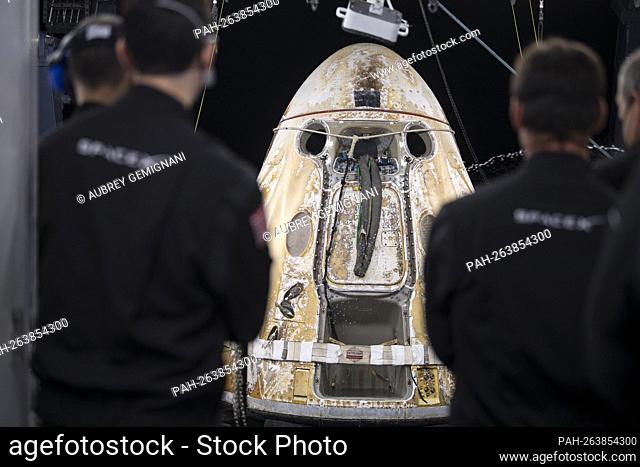 The SpaceX Crew Dragon Endeavour spacecraft is seen as it is lifted onto the SpaceX GO Navigator recovery ship shortly after having landed in the Gulf of Mexico...