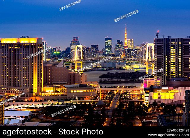 Aerial view of Tokyo Sunset with Tokyo tower and Rainbow bridge with Tokyo cityscape in background from Odaiba Japan
