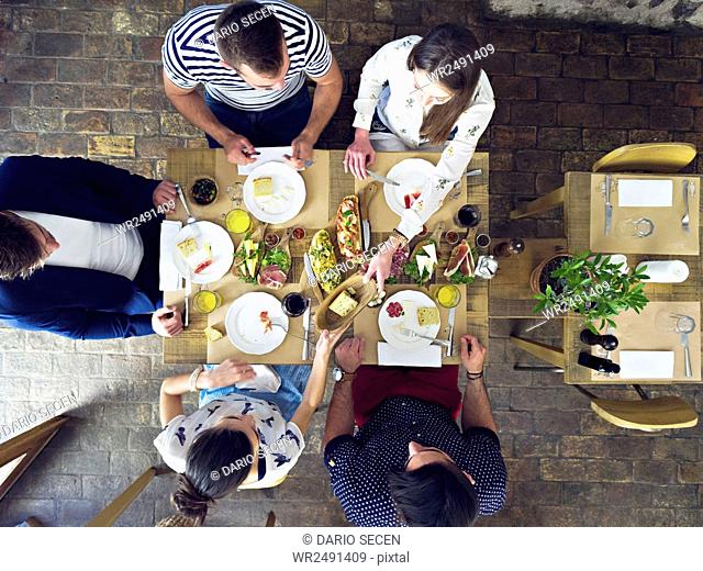 Group of friends having lunch in restaurant