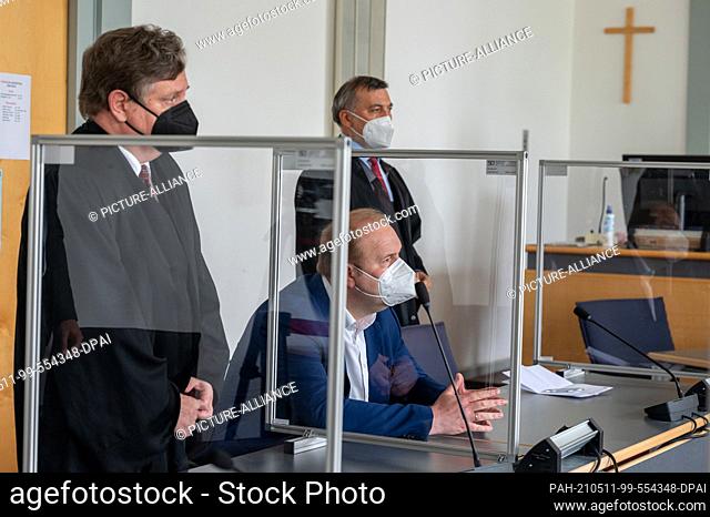 11 May 2021, Bavaria, Regensburg: Christian Schlegl, former candidate for mayor of Regensburg for the CSU (M), sits in the courtroom next to his defense...