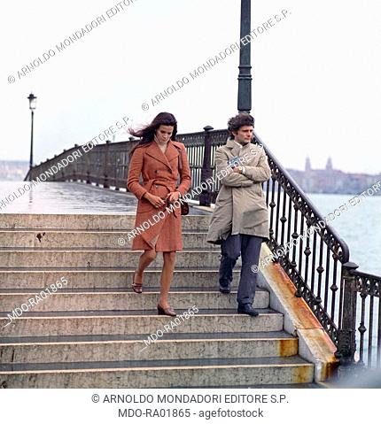 Brazilian actress Florinda Bolkan (Florinda Soares Bulcao) and American actor Tony Musante (Anthony Peter Musante) walking down a bridge in a scene from the...