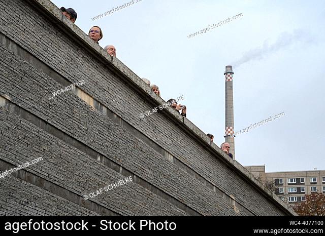 Berlin, Germany, Europe - Participants stand on the granite sculpture Sinking Wall at Invalidenpark during the opening of the protest rally ""In solidarity...