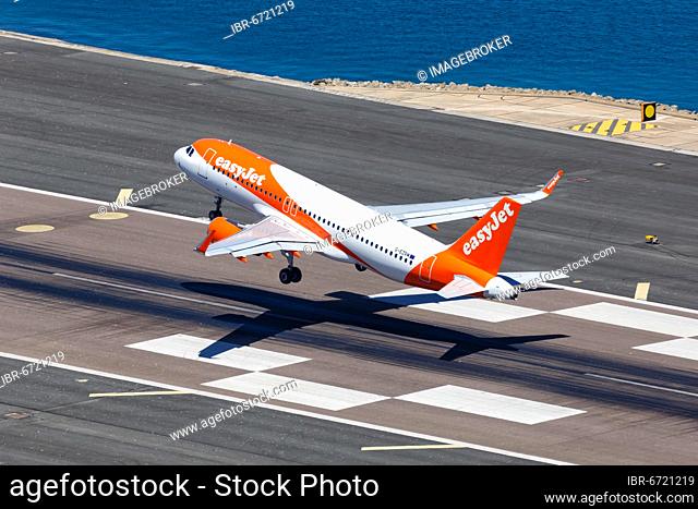 An Easyjet Airbus A320 with the registration G-EZRM takes off from Gibraltar Airport