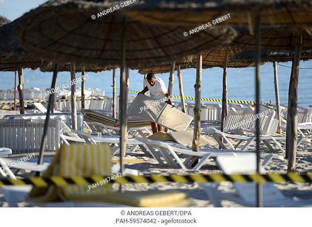 A hotel employee collects the mats for sun loungers at the beach of the Imperial Marhaba Hotel in Sousse, Tunisia, 27 June 2015