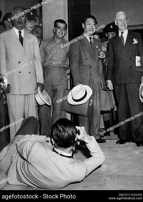 United Nations Committee Arrive In Palestine -- This press photographer got down to it when he photographed Chief Justice Emil Sandstrom of Sweden (right) and...